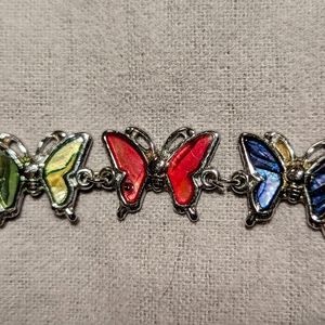 Paua shell butterfly bracelet (7" with 4" extension). Pink, blue, green